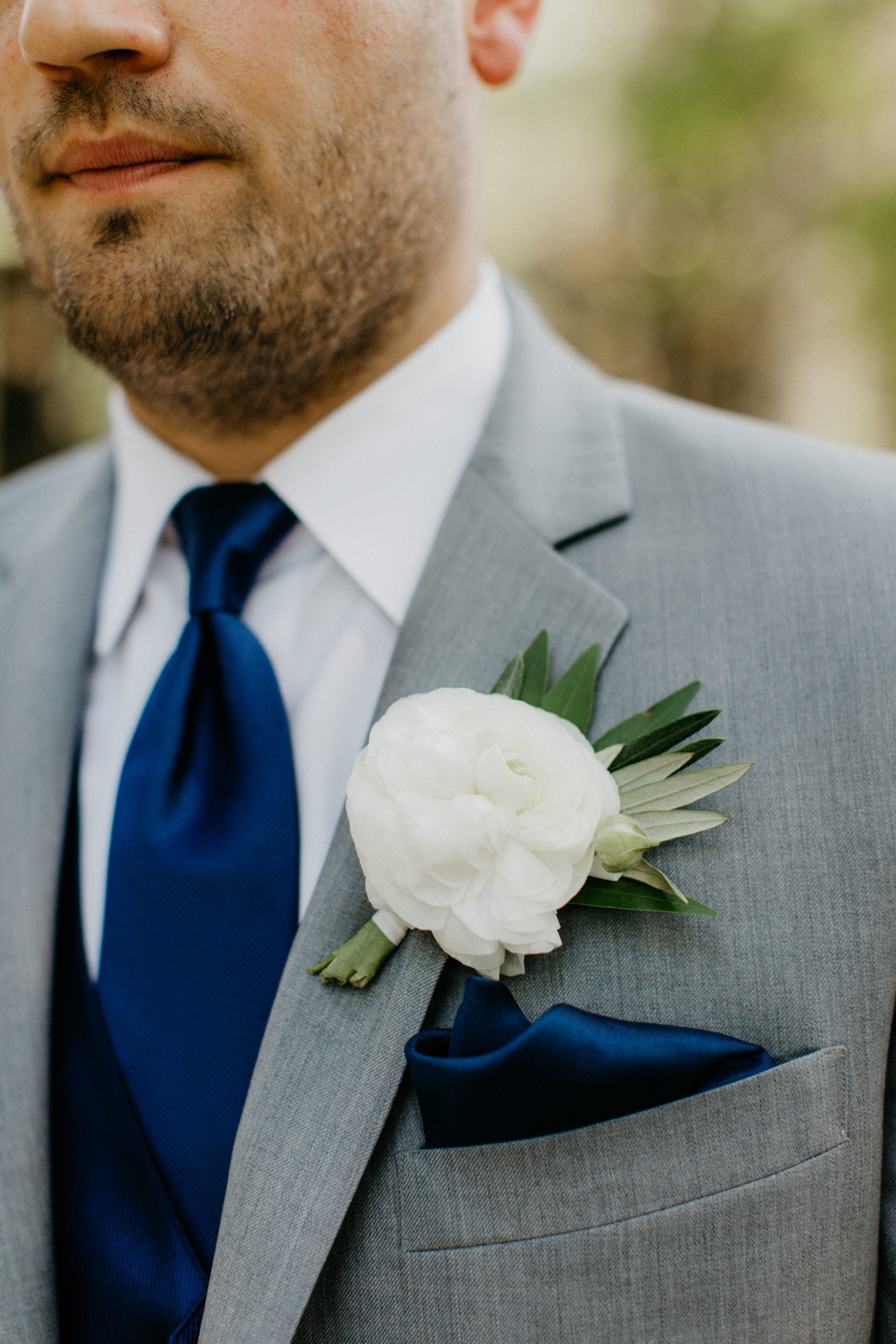 white and greenery boutonniere